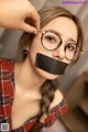 A woman with a black tape over her mouth.