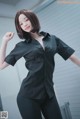 A woman in a black shirt and black pants posing for a picture.